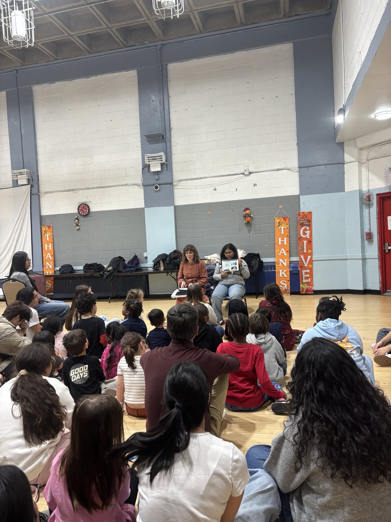 Volunteers reading to children at Amsterdam Houses community center